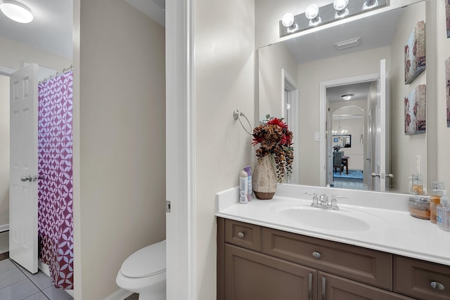 bathroom with visible vents, toilet, vanity, a shower with curtain, and tile patterned floors