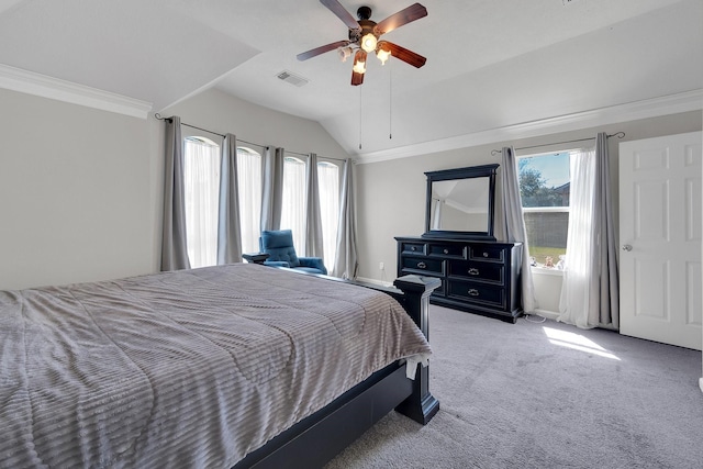 bedroom featuring visible vents, lofted ceiling, ceiling fan, ornamental molding, and carpet