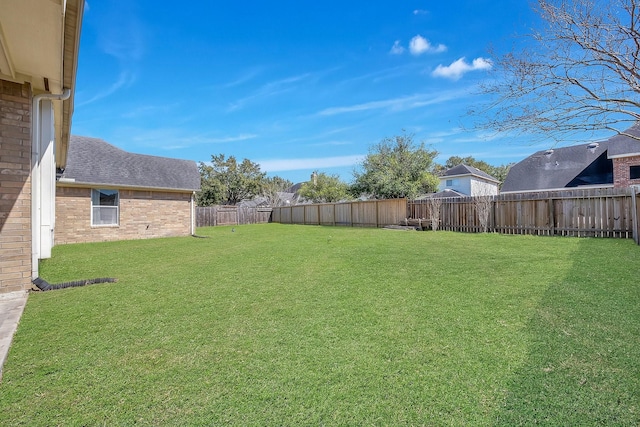 view of yard with a fenced backyard