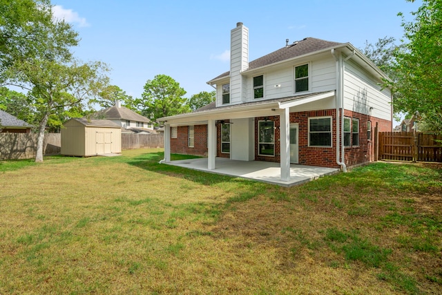 rear view of house featuring a fenced backyard, a shed, a patio, and brick siding