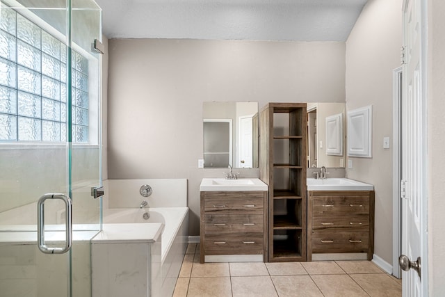 bathroom with a garden tub, vanity, a stall shower, and tile patterned floors