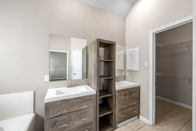 bathroom with two vanities, a sink, and tile patterned floors