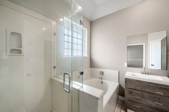 bathroom featuring tile patterned flooring, a garden tub, vanity, and a shower stall