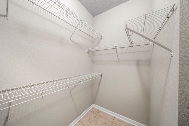 walk in closet featuring light tile patterned floors