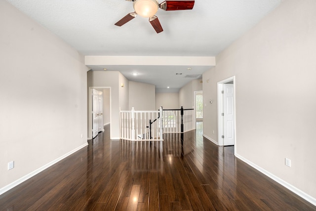 unfurnished room with ceiling fan, hardwood / wood-style flooring, and baseboards