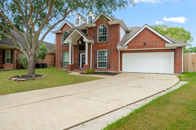 traditional-style house with a garage, concrete driveway, brick siding, and a front lawn