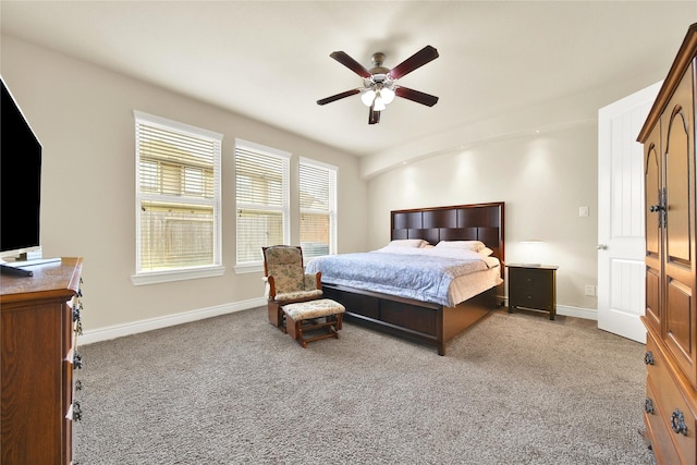 carpeted bedroom featuring ceiling fan and baseboards