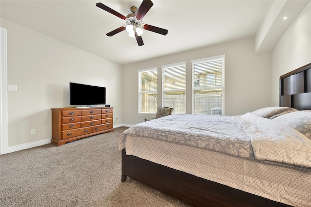 carpeted bedroom with a ceiling fan and baseboards