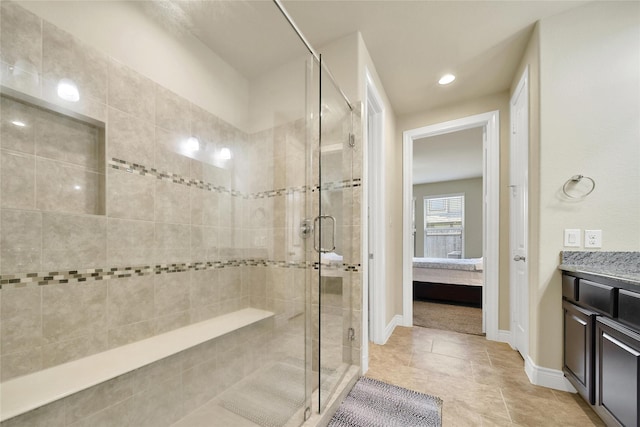 ensuite bathroom featuring ensuite bath, vanity, baseboards, and a shower stall