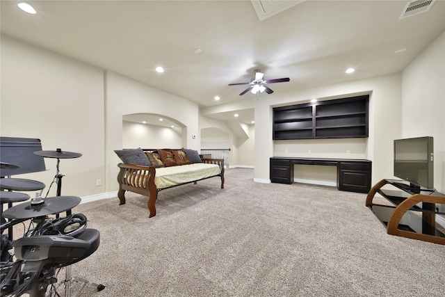 bedroom with light colored carpet, visible vents, arched walkways, and recessed lighting