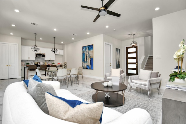 living room featuring visible vents, a ceiling fan, stairway, marble finish floor, and recessed lighting