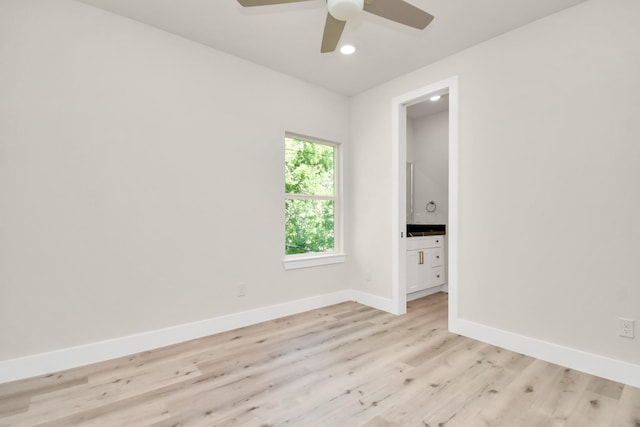 spare room featuring ceiling fan, recessed lighting, light wood-type flooring, and baseboards