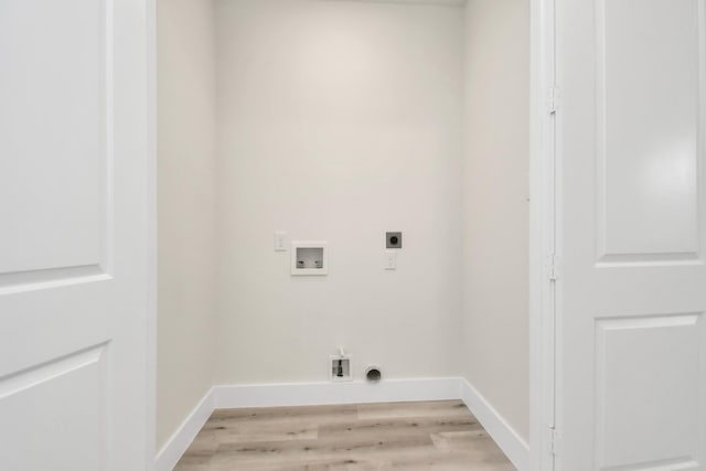 washroom featuring hookup for an electric dryer, laundry area, washer hookup, baseboards, and light wood-type flooring