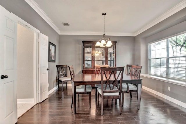 dining space with a chandelier, visible vents, baseboards, dark wood-style floors, and crown molding