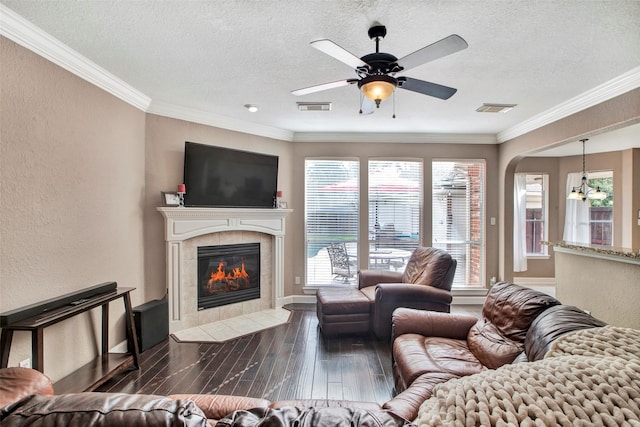 living room with crown molding, visible vents, and wood finished floors