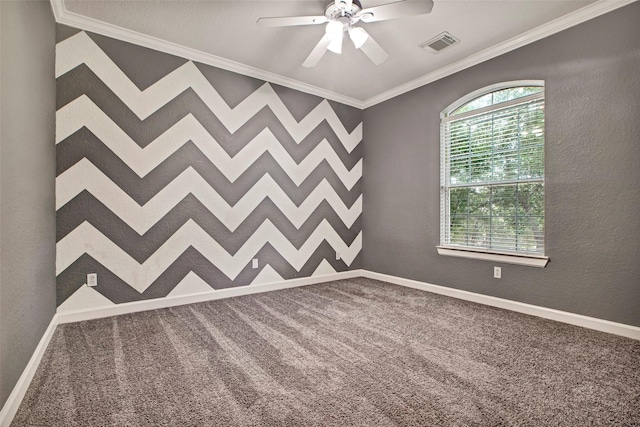 unfurnished room featuring visible vents, ornamental molding, a ceiling fan, carpet flooring, and baseboards