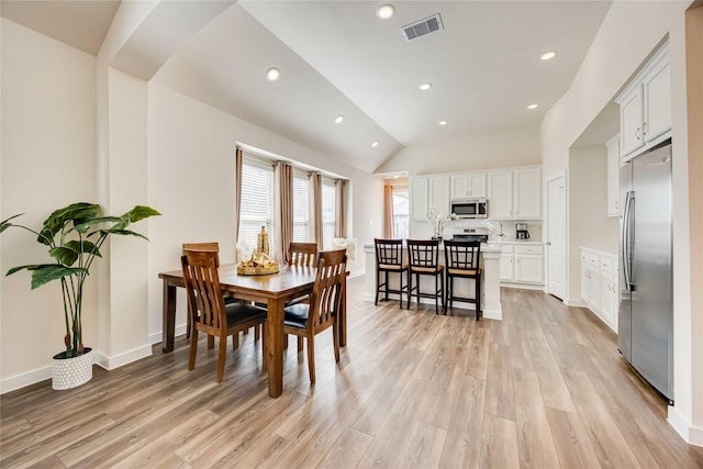 dining area featuring light wood finished floors, lofted ceiling, recessed lighting, visible vents, and baseboards