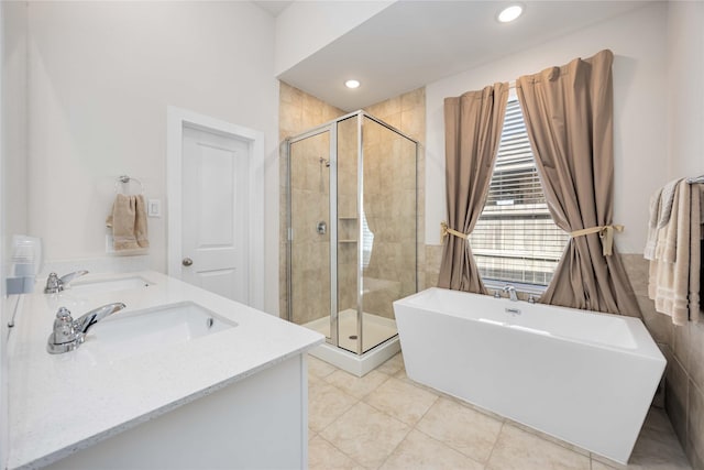 bathroom with a soaking tub, a sink, and a shower stall