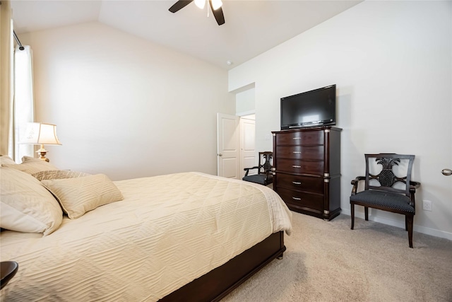 bedroom featuring light colored carpet, vaulted ceiling, baseboards, and ceiling fan