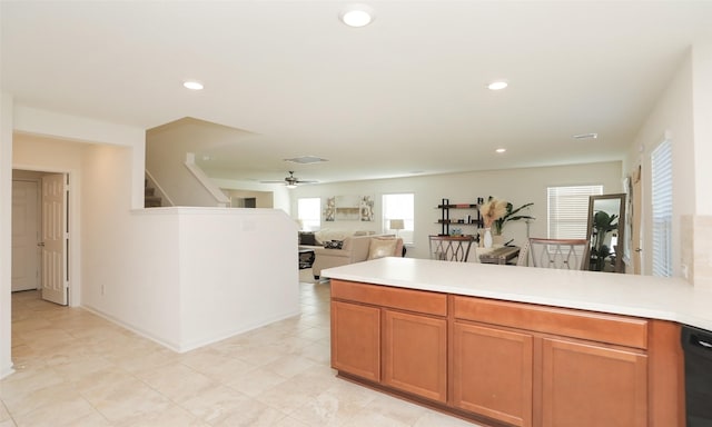 kitchen with recessed lighting, open floor plan, light countertops, and a peninsula