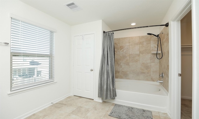 bathroom with shower / tub combo, visible vents, baseboards, and tile patterned floors