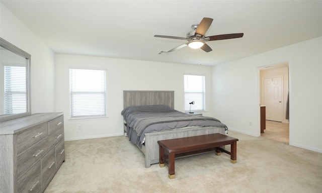 bedroom featuring baseboards, a ceiling fan, visible vents, and light colored carpet