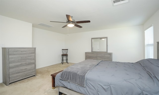 bedroom featuring visible vents, ceiling fan, and light carpet