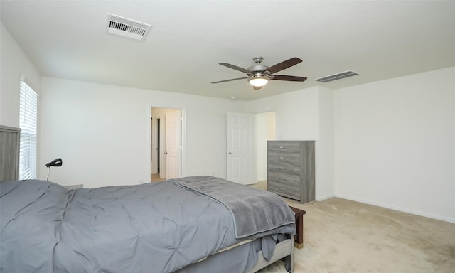 bedroom with baseboards, a ceiling fan, visible vents, and light colored carpet