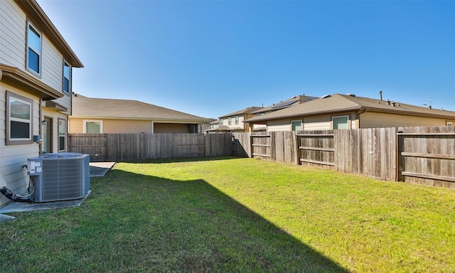 view of yard featuring central air condition unit and a fenced backyard