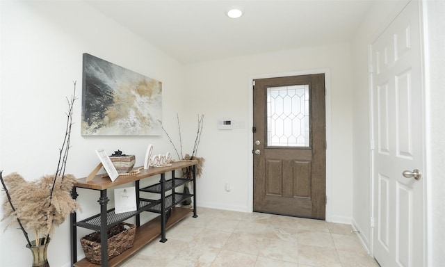 foyer featuring baseboards