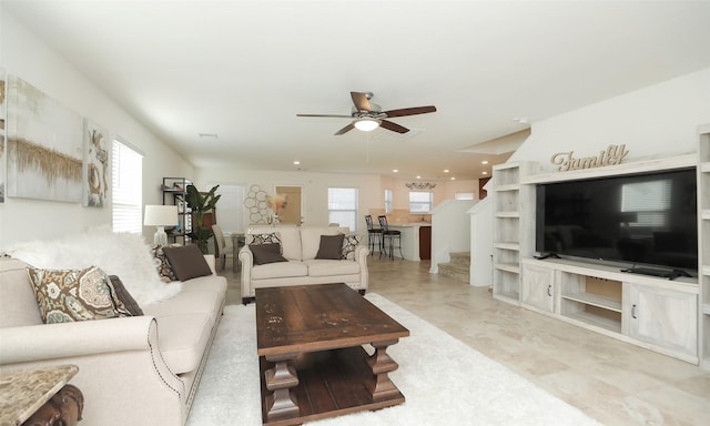 living room featuring stairway and a ceiling fan