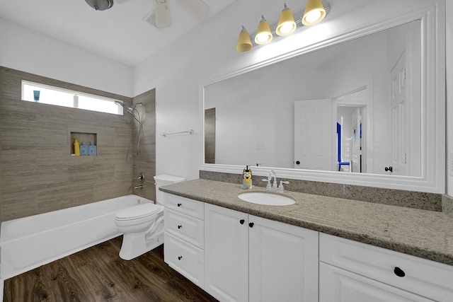 full bathroom with shower / bath combination, vanity, toilet, and wood finished floors