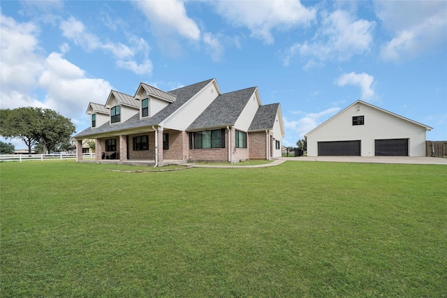 cape cod-style house with an outbuilding, brick siding, fence, a standing seam roof, and a front yard