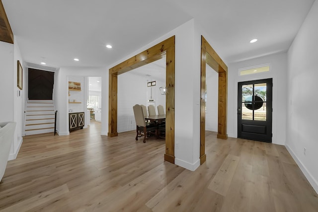 entryway with light wood-type flooring, stairs, baseboards, and recessed lighting