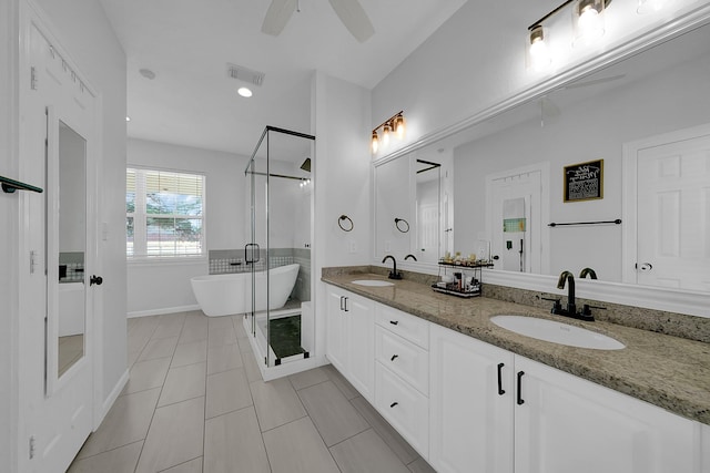 bathroom featuring a freestanding tub, a sink, a shower stall, and double vanity