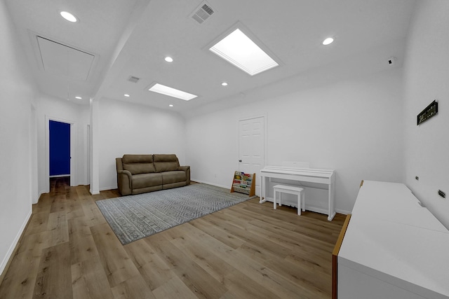 unfurnished room with visible vents, light wood-style flooring, attic access, and recessed lighting