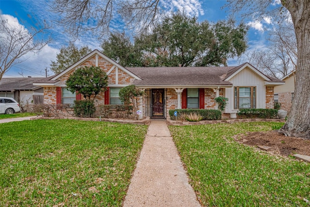 ranch-style house with a front lawn, a shingled roof, and brick siding