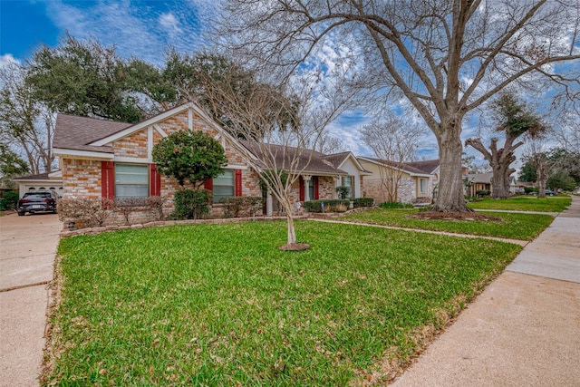 single story home featuring a shingled roof, a front yard, and brick siding