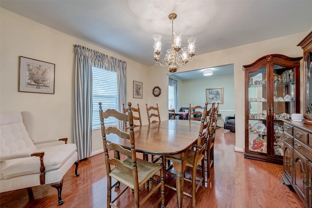 dining room featuring a notable chandelier and light wood finished floors