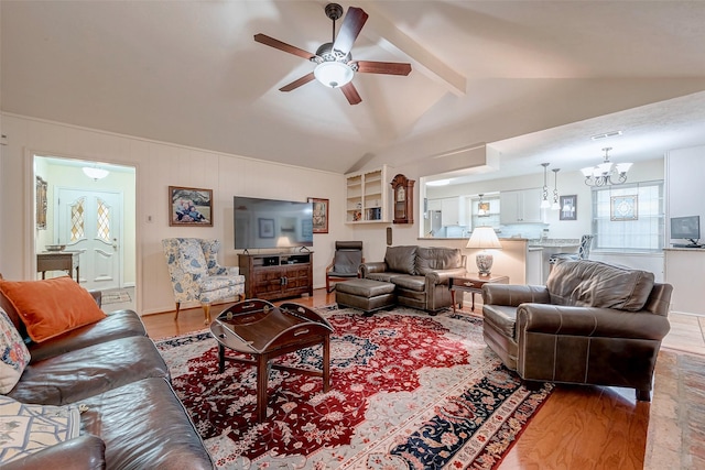 living area with visible vents, lofted ceiling with beams, light wood finished floors, and ceiling fan with notable chandelier