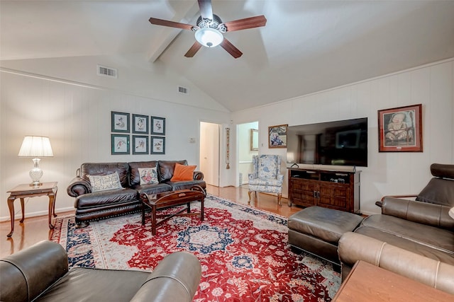 living area featuring lofted ceiling with beams, ceiling fan, wood finished floors, and visible vents