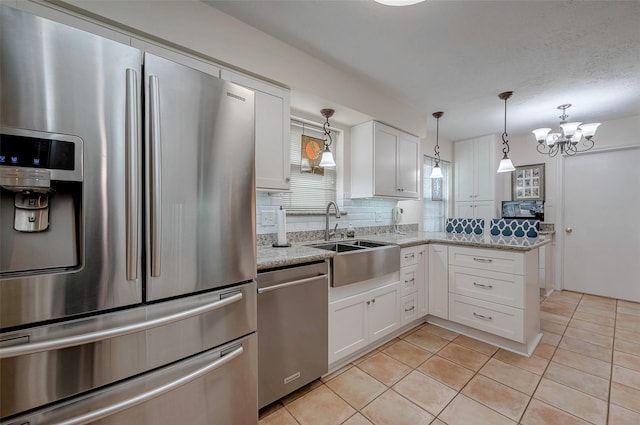 kitchen featuring white cabinetry, appliances with stainless steel finishes, a sink, and light tile patterned flooring