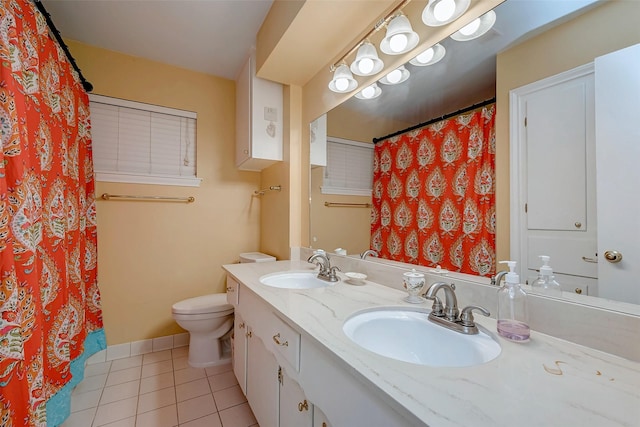 bathroom with tile patterned flooring, a sink, toilet, and baseboards