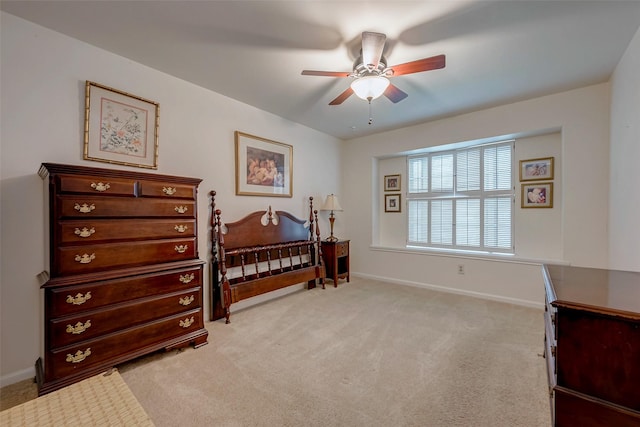 bedroom featuring light carpet, ceiling fan, and baseboards