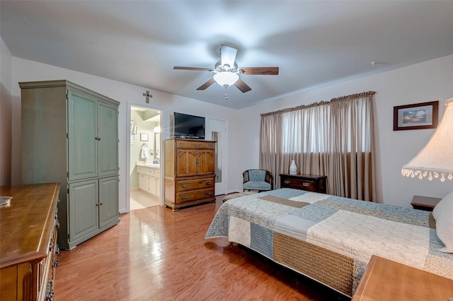 bedroom featuring light wood-type flooring, ceiling fan, and ensuite bathroom