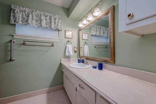 bathroom featuring baseboards, vanity, and tile patterned floors