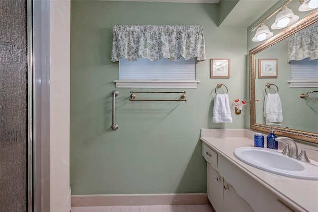 bathroom featuring baseboards and vanity