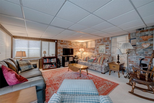 carpeted living room with a paneled ceiling