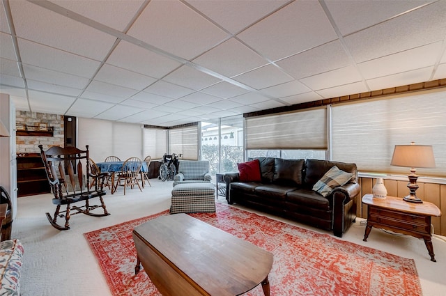 living room featuring carpet floors and a paneled ceiling