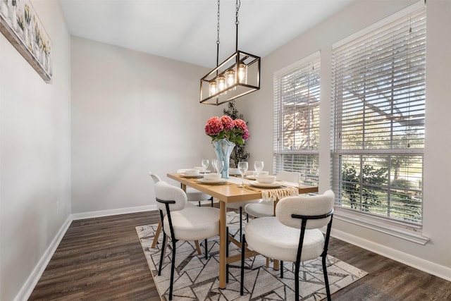 dining room with dark wood-style flooring and baseboards